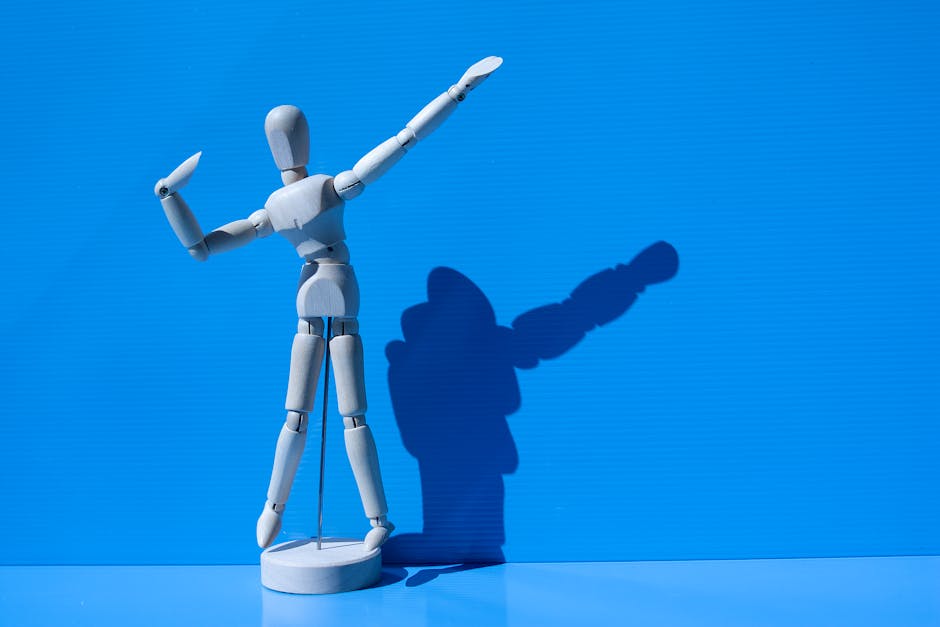 Wooden mannequin striking a pose with a dramatic shadow against a vibrant blue background.