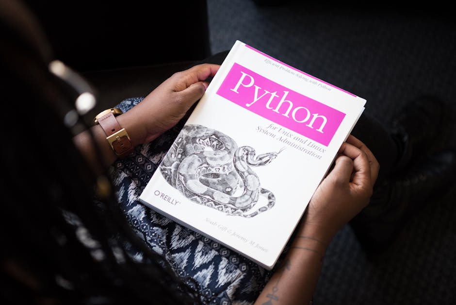 A person reads ‘Python for Unix and Linux System Administration’ indoors.