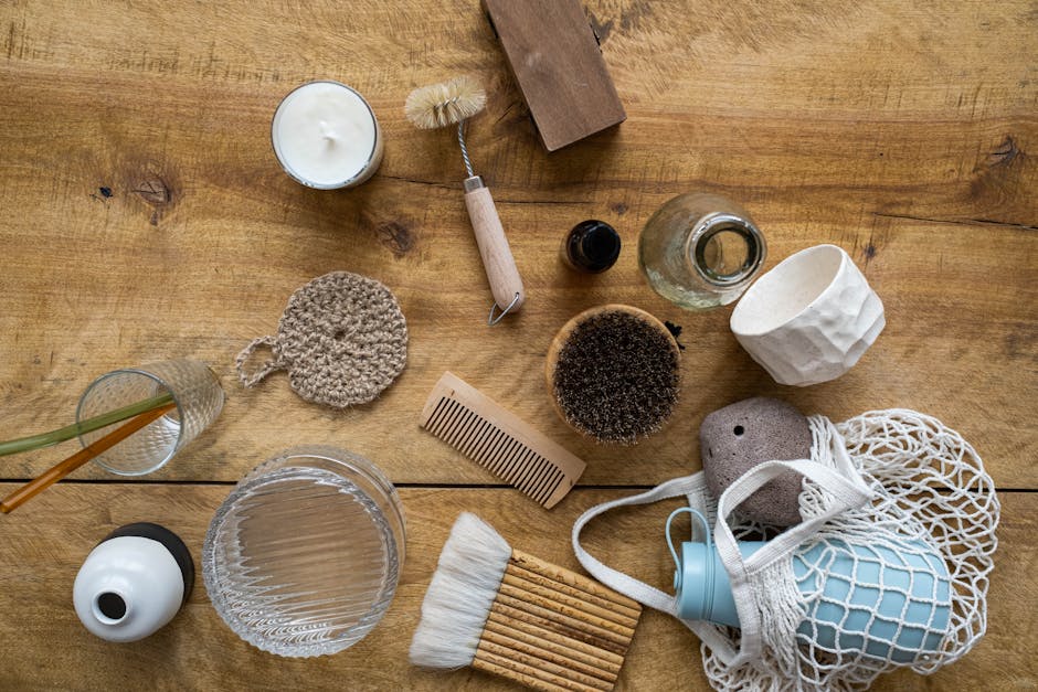 Flat lay of various eco-friendly household items on a wooden surface for a sustainable lifestyle.