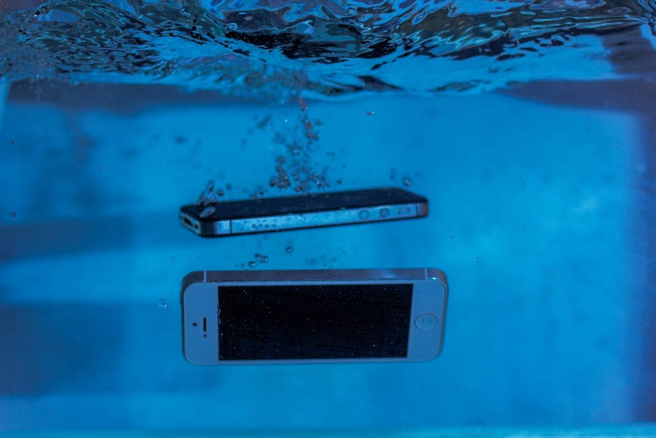 Two smartphones immersed underwater with bubbles, showcasing water-resistant test perspectives.