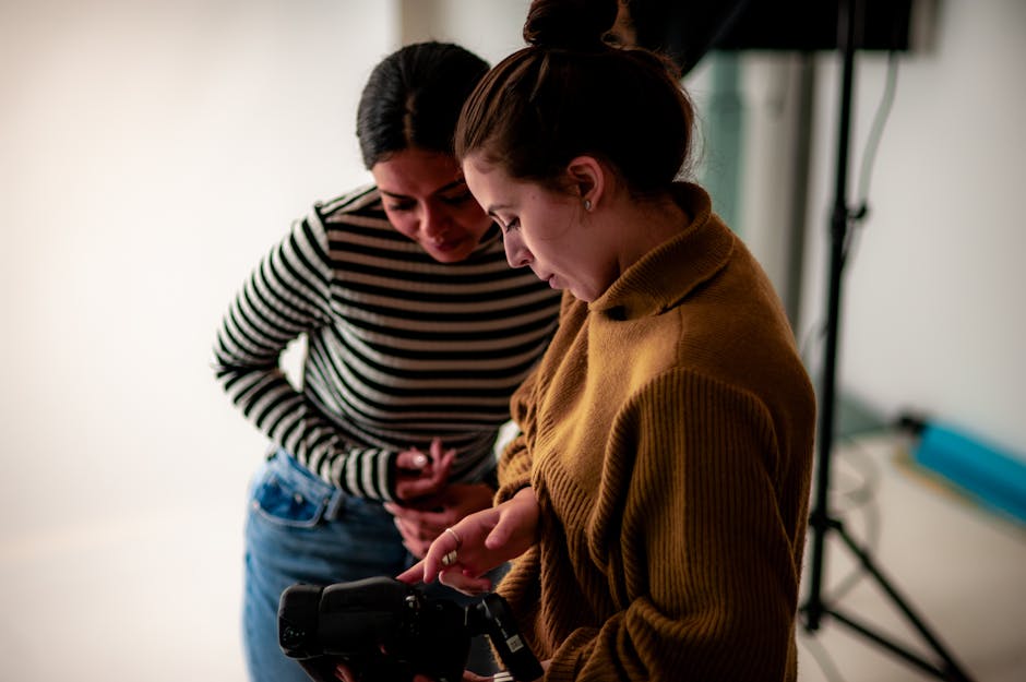 Two women checking camera images in a Berlin studio environment.