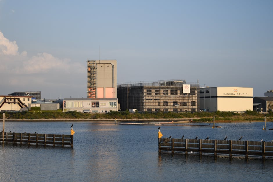 Scenic view of waterfront with industrial buildings and calm water.