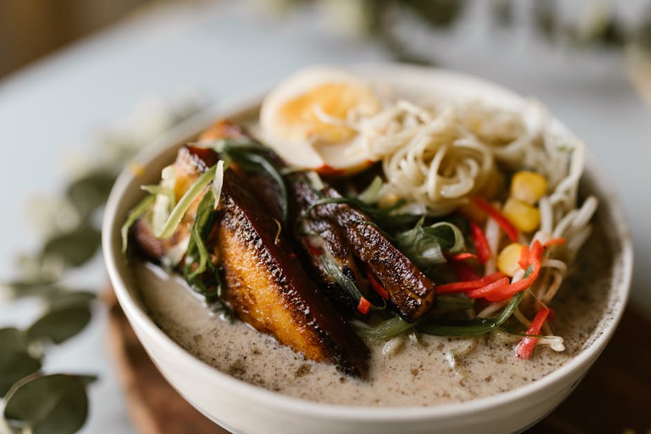 A savory bowl of ramen with pork belly, egg, and vegetables, perfect for food enthusiasts.