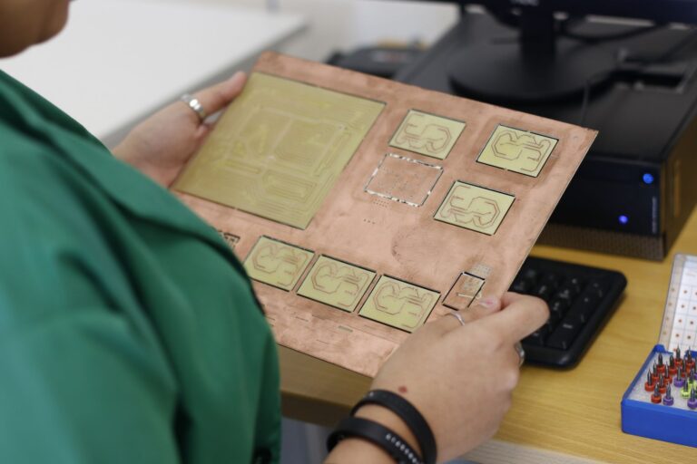 Maintenance technician with practical tools comparing before-and-after performance dashboards printed on paper