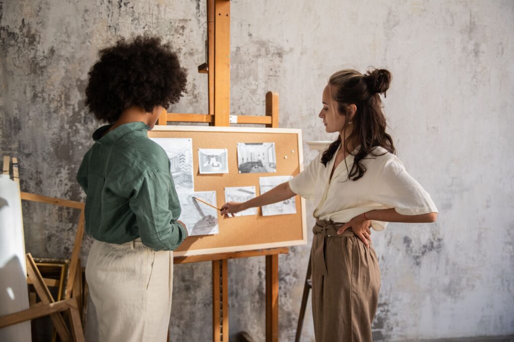 Small team gathered around a stage-two release checklist on a corkboard with pinned cards
