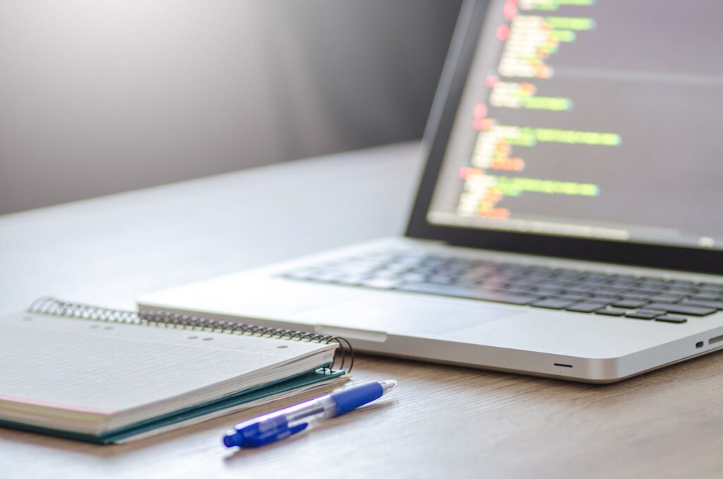 Environment setup tools and printed CI configuration sheet on a developer's planning desk