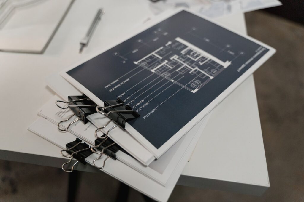 Release readiness packet open on a desk with documentation, runbook, and release notes pages stacked