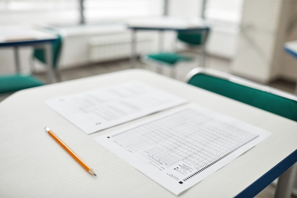Numbered criteria sheet on a desk with weight values circled in pencil