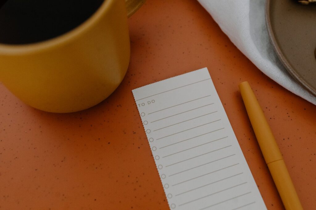 Buyer quality review checklist next to a steaming cup of tea on a planning desk