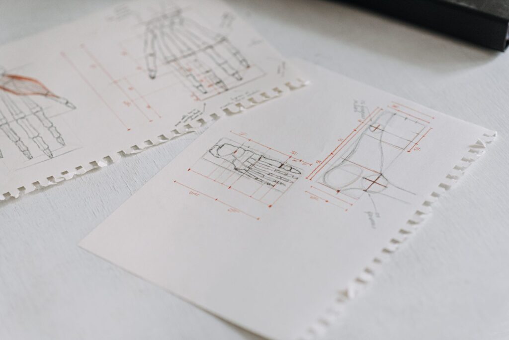 Cost category icons drawn on graph paper showing discovery, build, QA, documentation, and maintenance lines