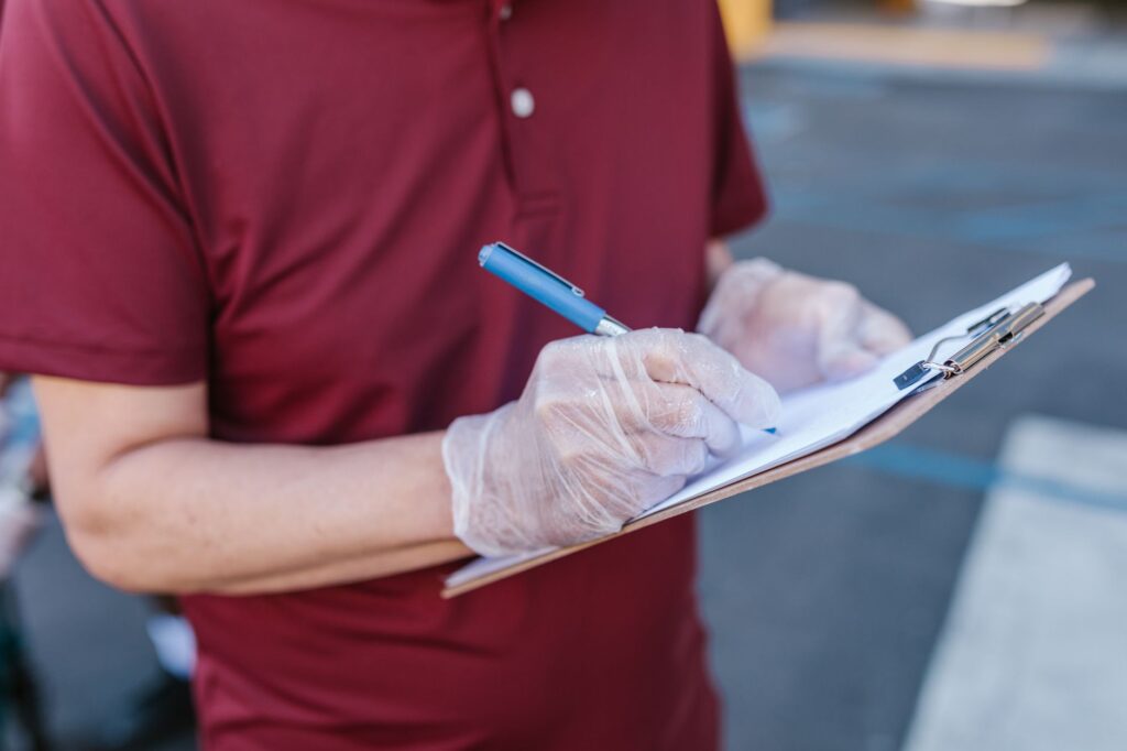 First-pass filter checklist on a clipboard with several candidates already crossed out