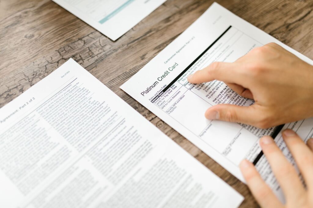 Decision table on a printed sheet with three candidate columns and ratings written in pencil